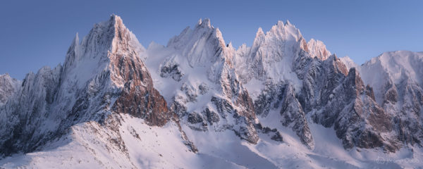 Panorama des Aiguilles de Chamonix à l'heure bleue en hiver. Massif du Mont-Blanc.